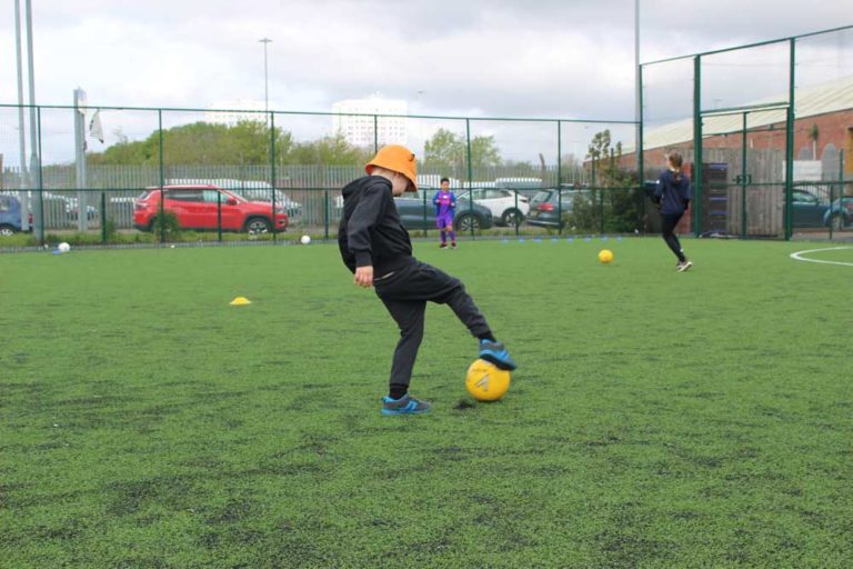 Young boy practicing with a ball