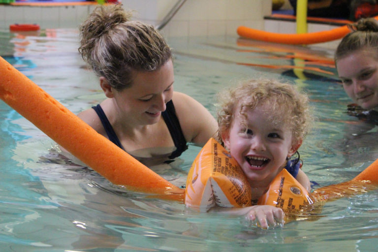 Physioterapist in Hydrotherapy pool with young child