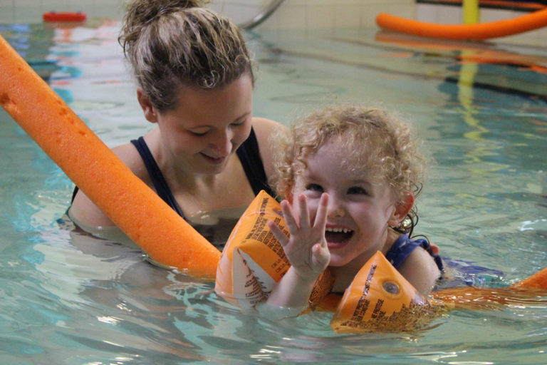 Physioterapist in Hydrotherapy pool with young child
