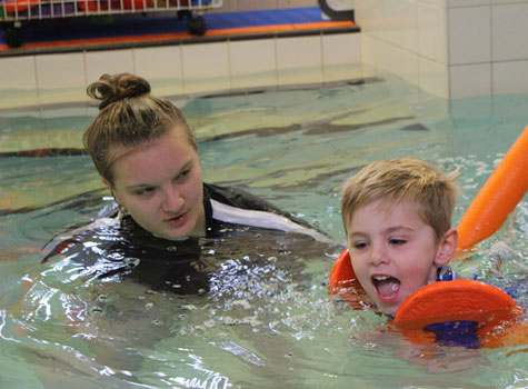 Young boy learning to swim