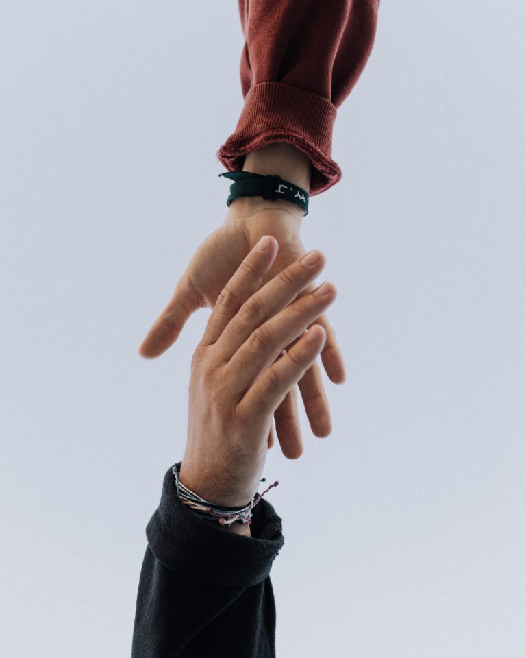 Hands reaching out to help each other