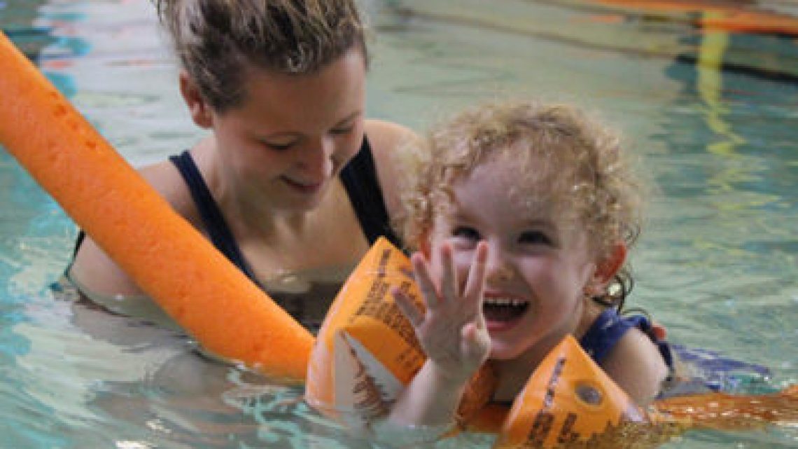 Young child enjoying Hydrotherapy with a physio