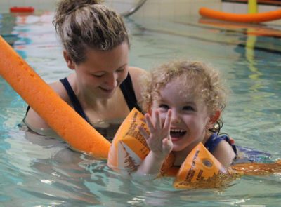 Young child enjoying Hydrotherapy with a physio