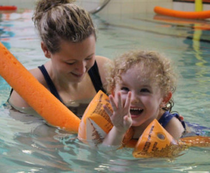 Young child enjoying Hydrotherapy with a physio