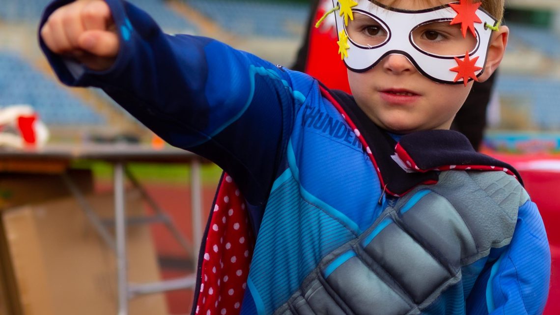 Little boy wearing superhero costume