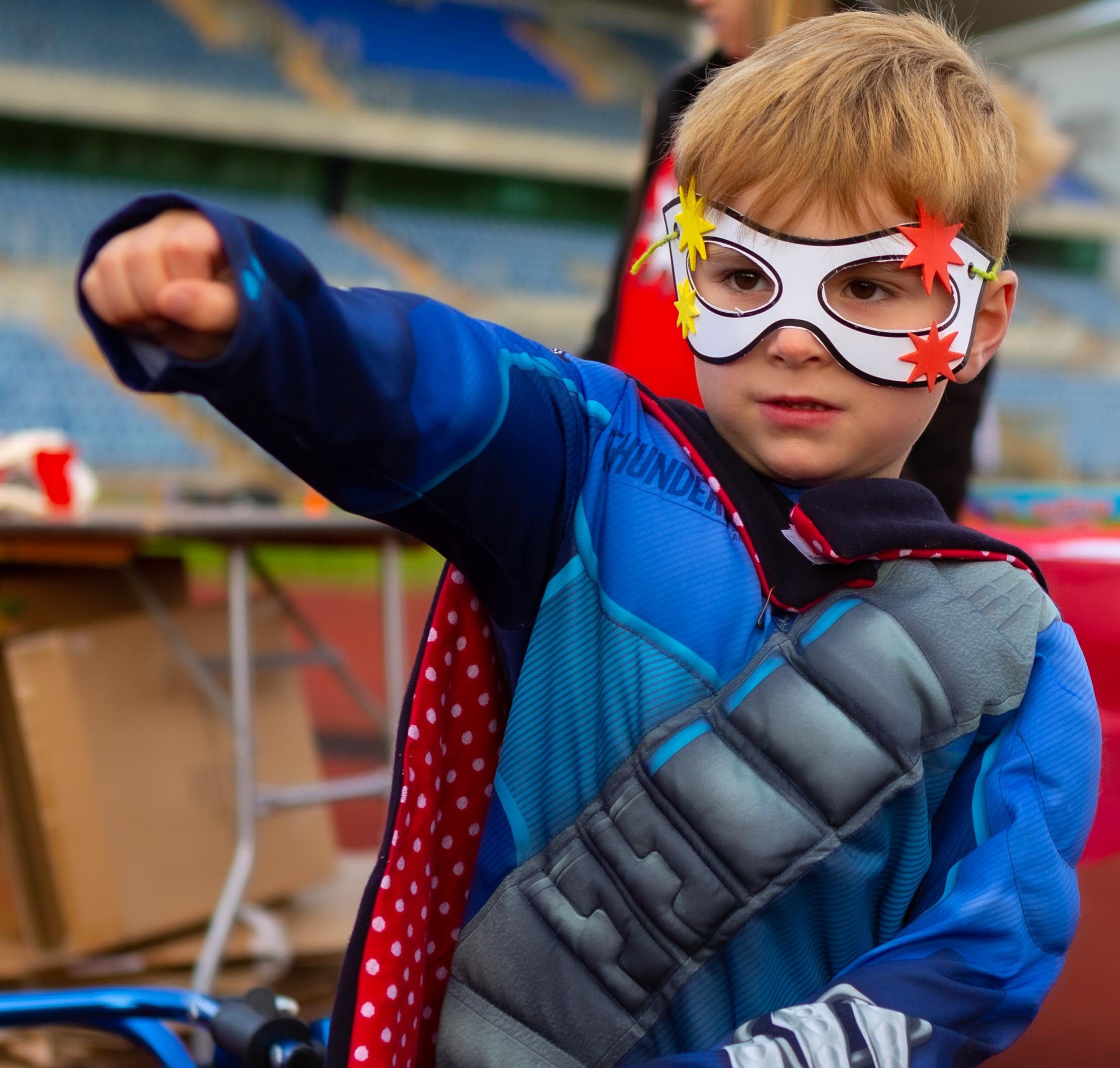 Little boy wearing superhero costume