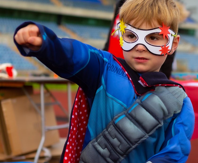 Little boy wearing superhero costume